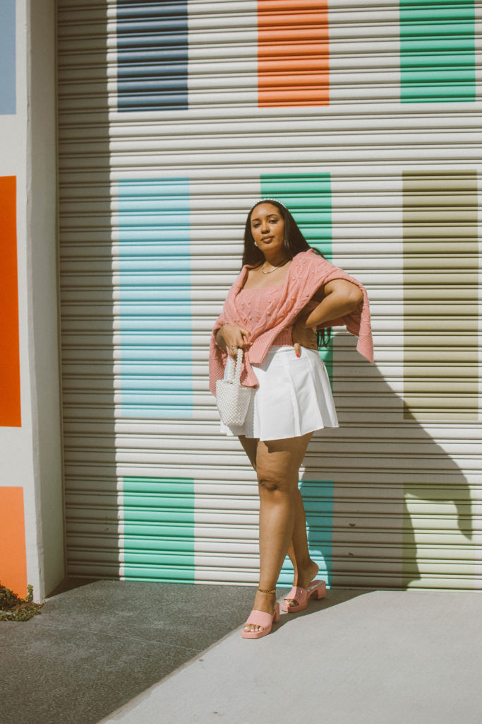 Valentine’s Day Outfit Inspiration: Pink cable knit cardigan and bralet set from River Island, white pleated tennis skirt, Gucci Woman’s rubber slide sandal 