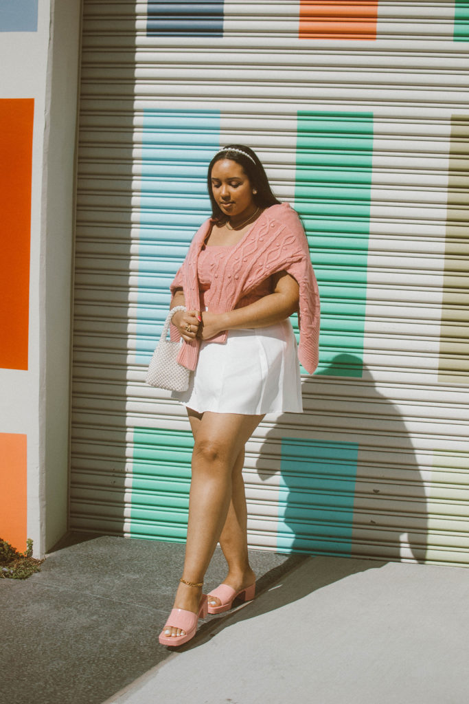 Valentine’s Day Outfit Inspiration: Pink cable knit cardigan and bralet set from River Island, white pleated tennis skirt, Gucci Woman’s rubber slide sandal