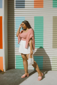 Valentine’s Day Outfit Inspiration: Pink cable knit cardigan and bralet set from River Island, white pleated tennis skirt, Gucci Woman’s rubber slide sandal