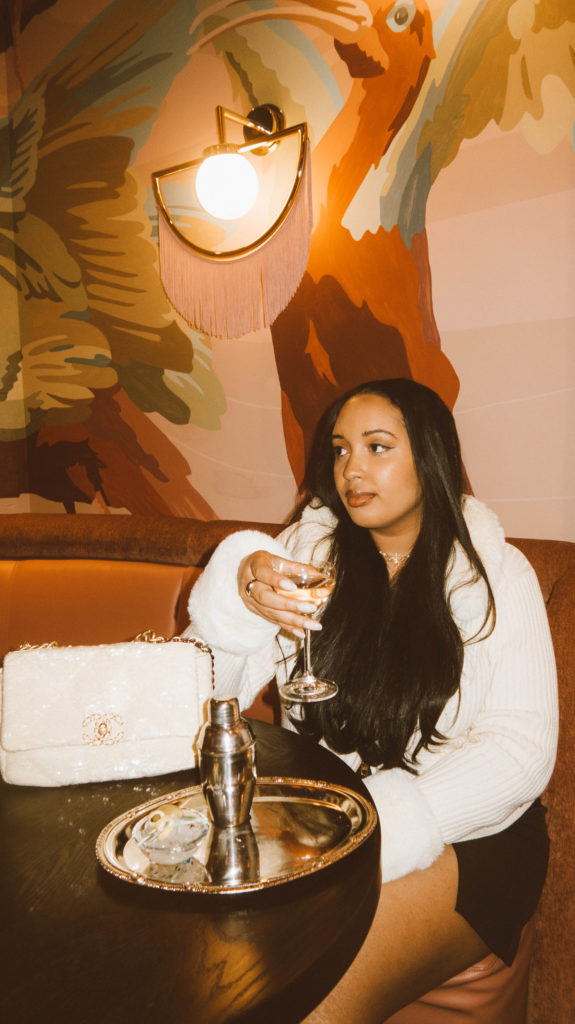 Girl sitting at a table at Atrium Atlanta, located at Ponce City Market.